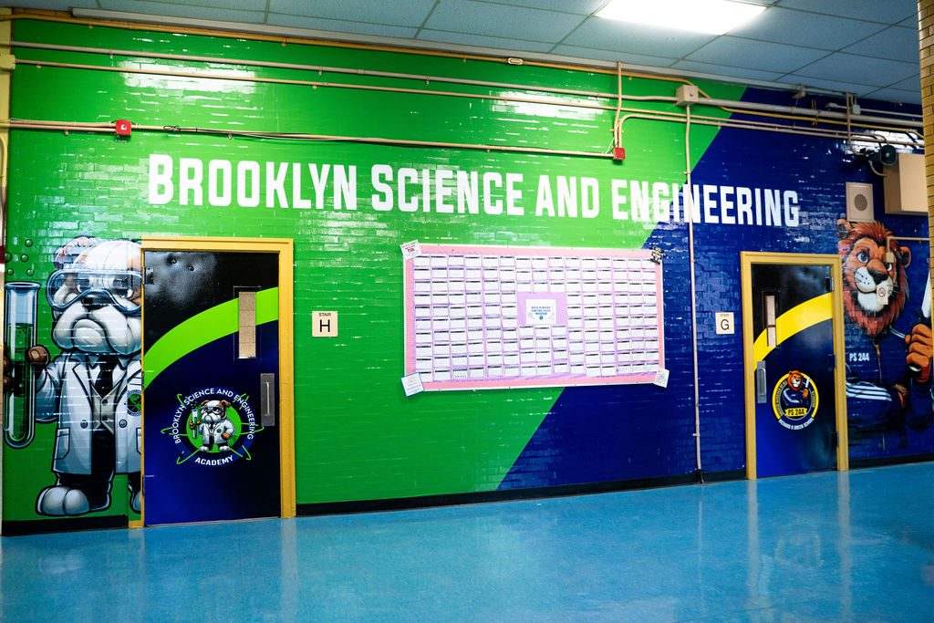 Full-wall branded cafeteria environment in school colors with mascots