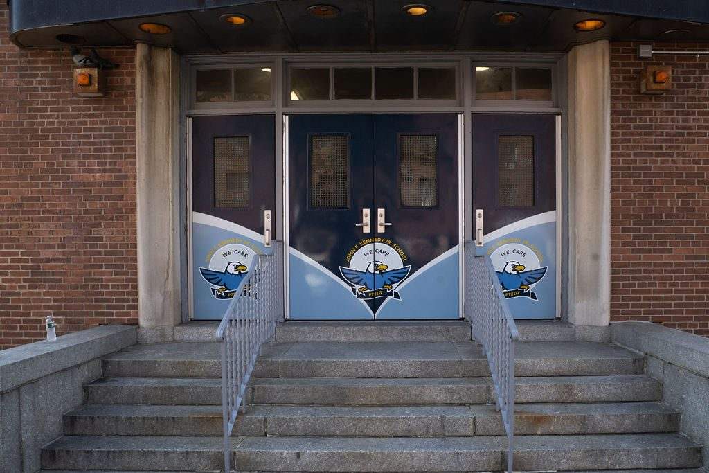 Double-door main entrance treatment with matching crest graphics