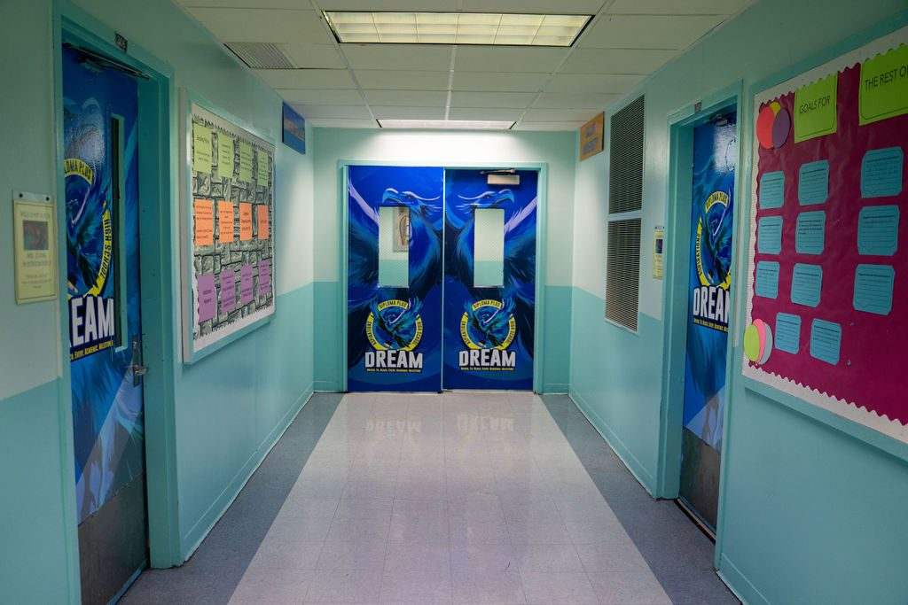 Symmetrical corridor of branded DREAM doors with filled bulletin boards